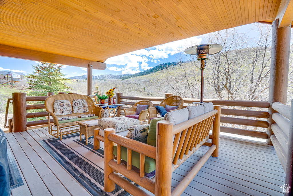 Deck with a mountain view and an outdoor hangout area