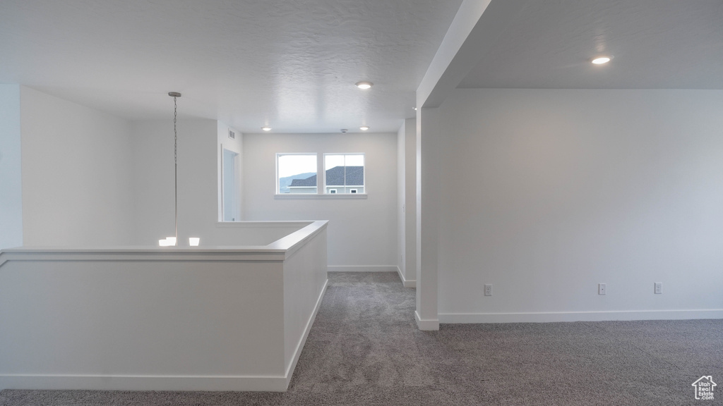 Carpeted spare room featuring baseboards and recessed lighting