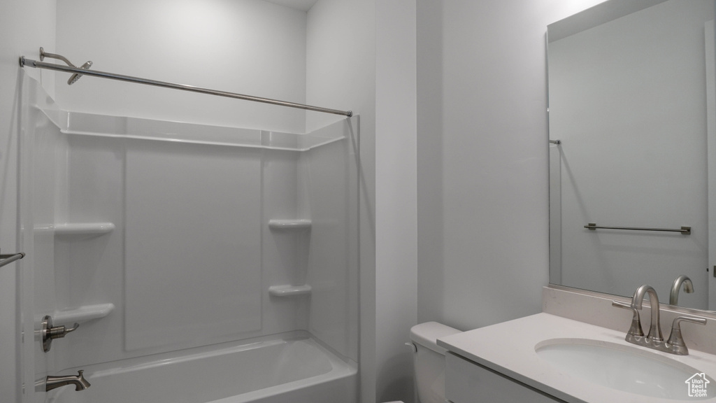 Full bathroom featuring bathing tub / shower combination, vanity, and toilet