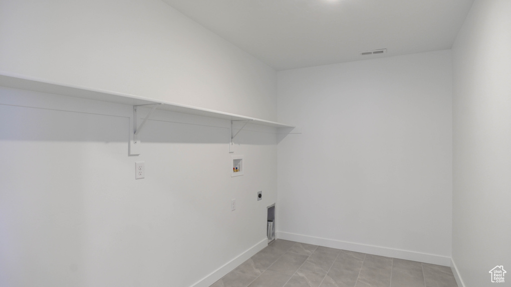 Laundry area with hookup for a washing machine, hookup for an electric dryer, and baseboards