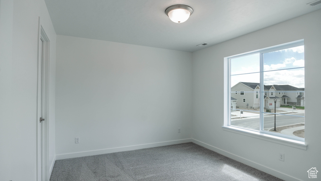 Spare room with baseboards and carpet flooring