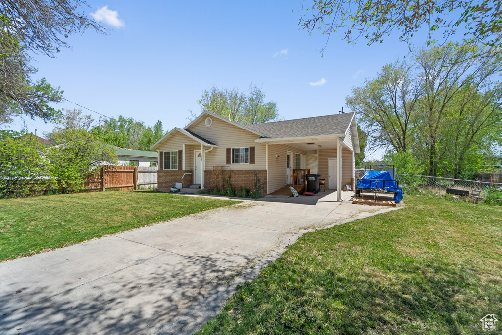 Ranch-style home featuring driveway, brick siding, and roof with shingles