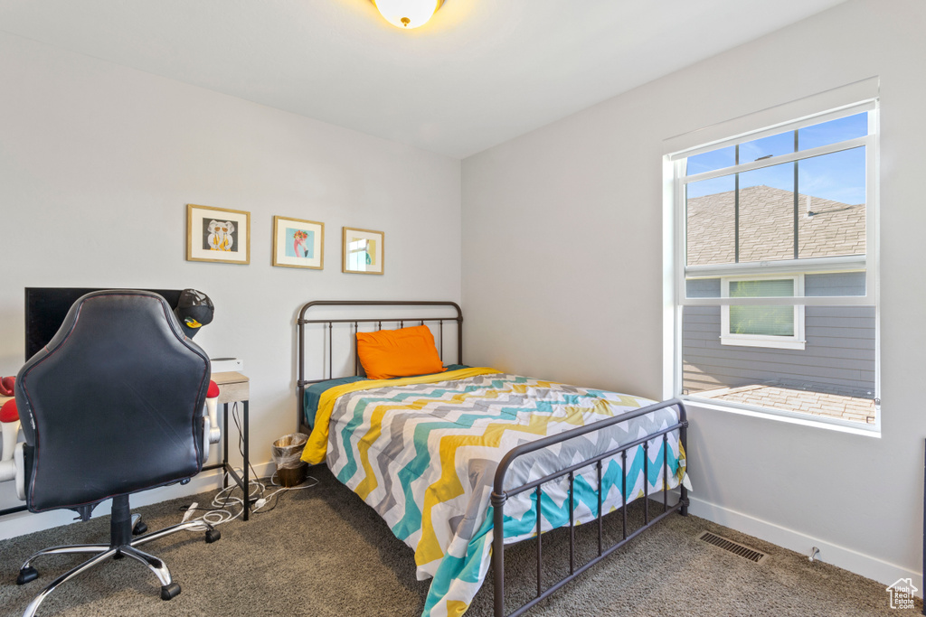 Bedroom with baseboards, carpet, and visible vents