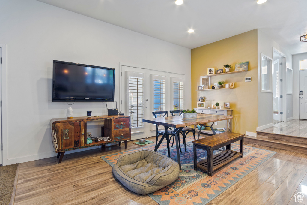 Dining room featuring baseboards, light wood finished floors, and recessed lighting
