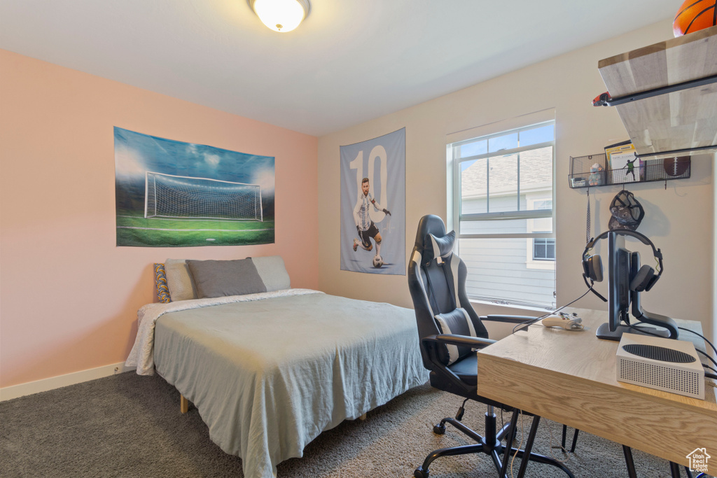 Carpeted bedroom featuring baseboards