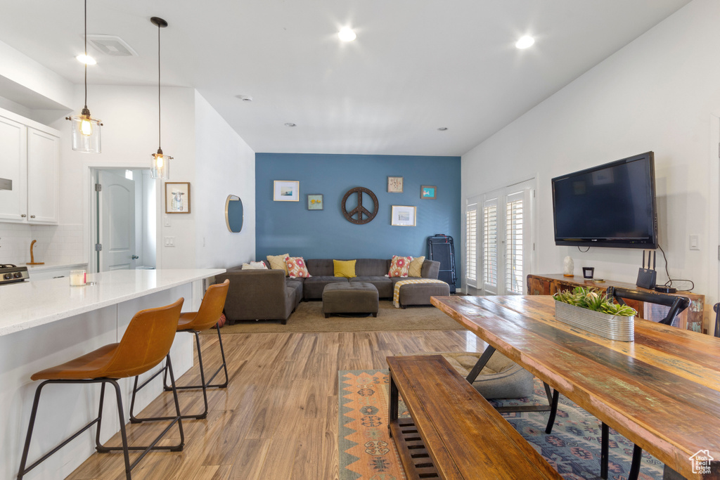 Living room featuring recessed lighting, light wood finished floors, and visible vents