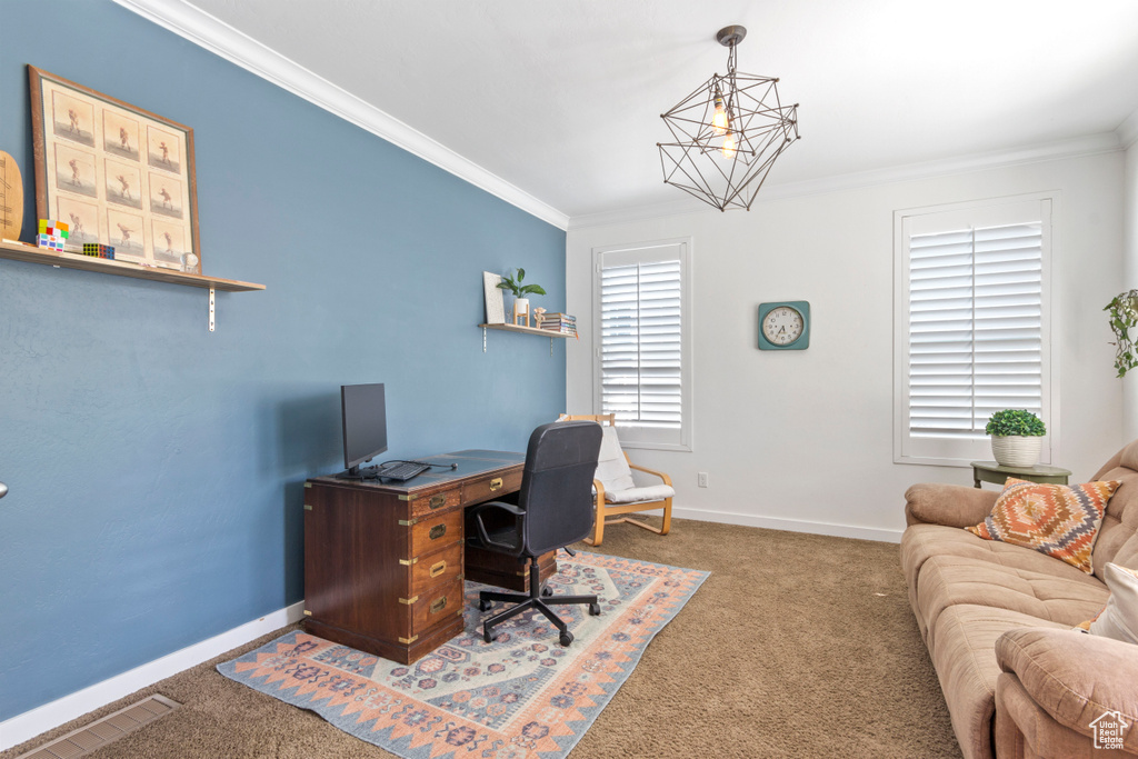 Home office featuring baseboards, carpet flooring, visible vents, and ornamental molding
