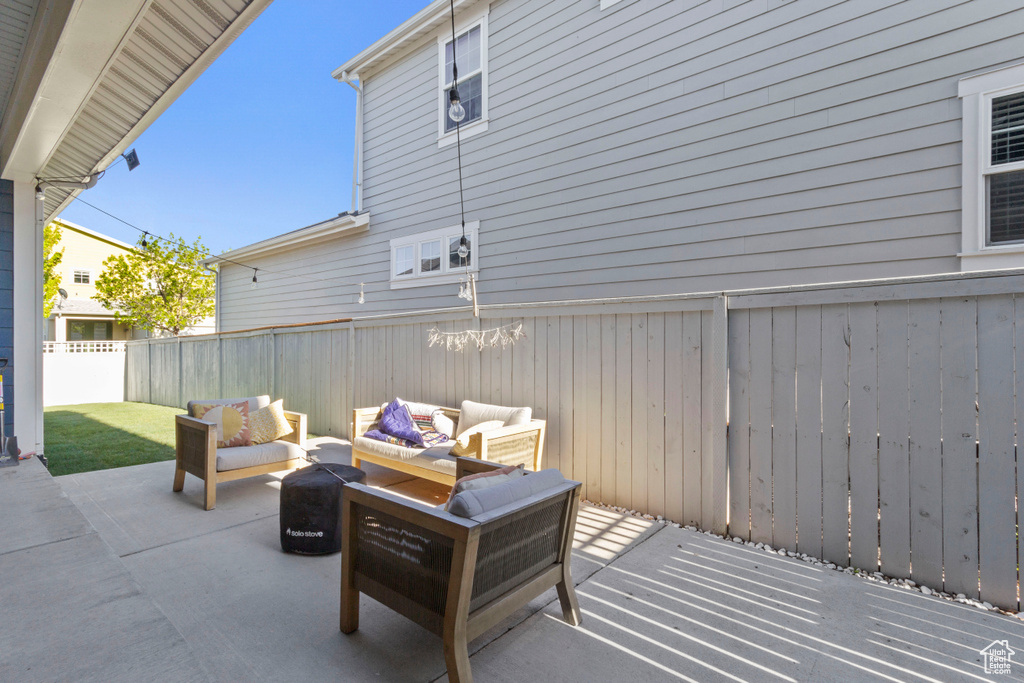 View of patio featuring an outdoor living space and a fenced backyard