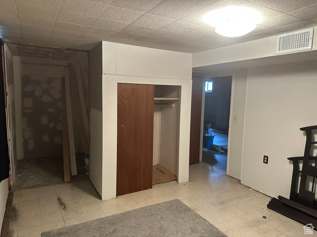 Unfurnished bedroom with light floors and a closet