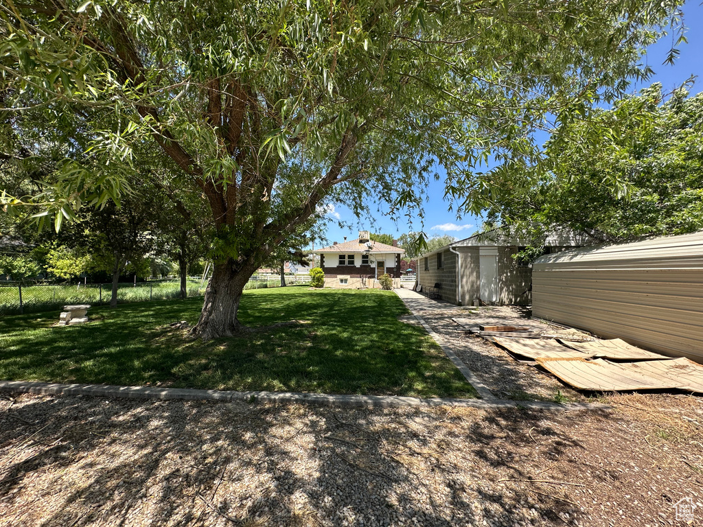 View of grassy yard with an outdoor structure