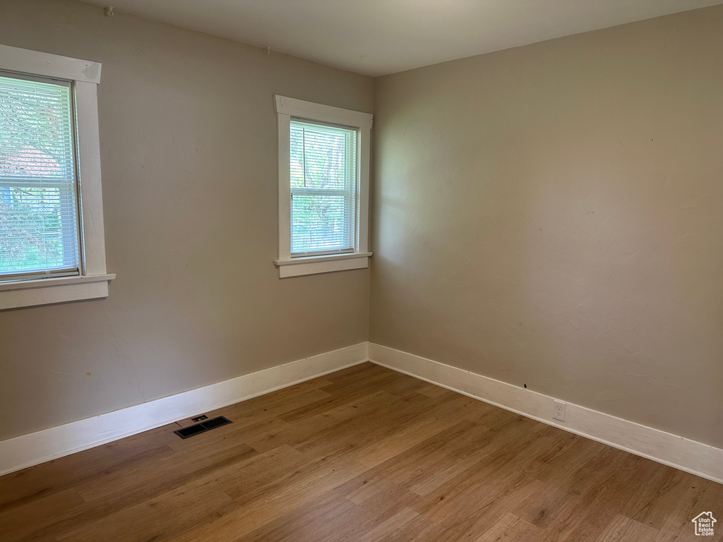 Spare room with light wood-type flooring and baseboards