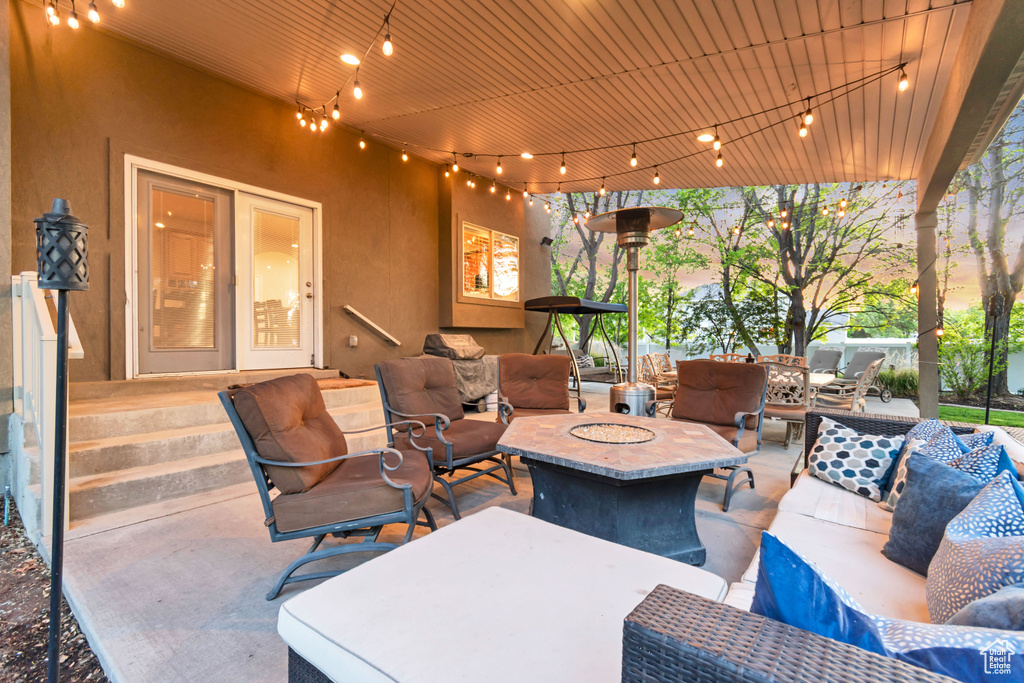View of patio with an outdoor living space with a fire pit