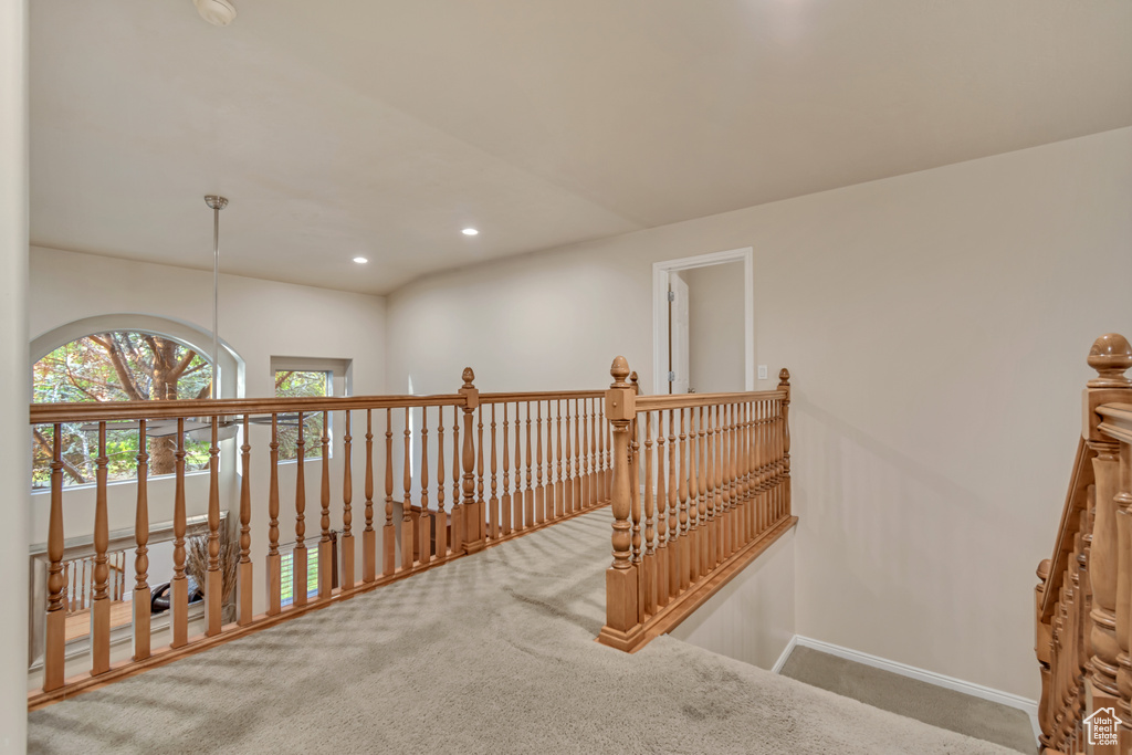 Hall with carpet, an upstairs landing, baseboards, and recessed lighting