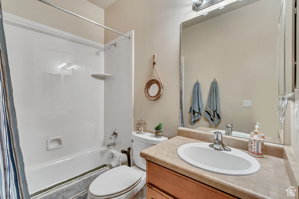 Full bathroom with toilet, bathing tub / shower combination, and vanity