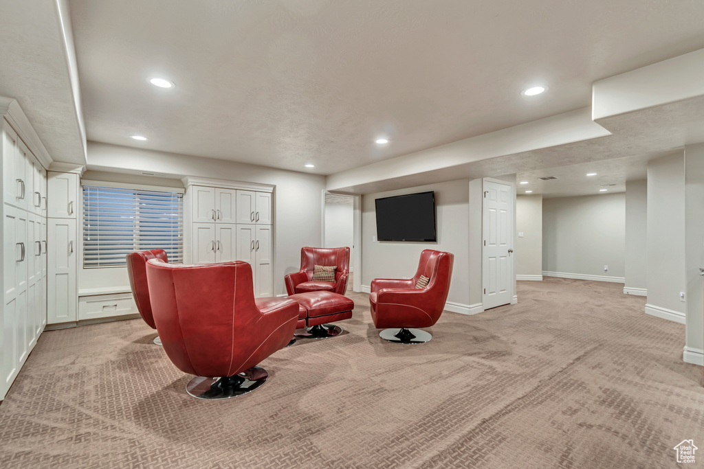 Living area featuring light colored carpet, recessed lighting, and baseboards