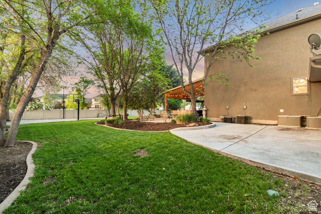 View of yard with a patio and central AC unit
