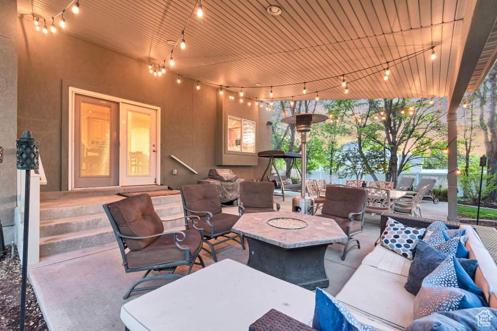View of patio with an outdoor living space with a fire pit