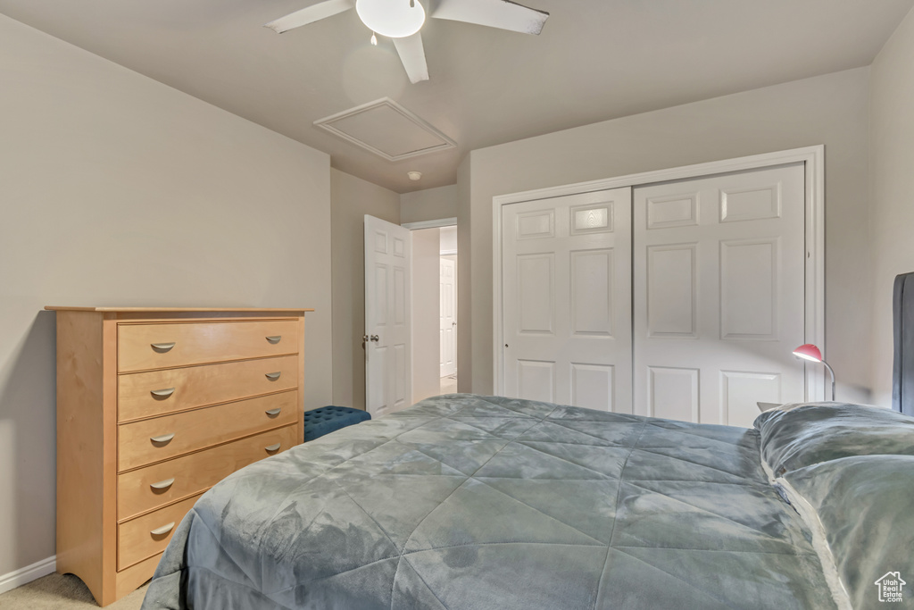 Bedroom featuring attic access, a ceiling fan, a closet, and baseboards