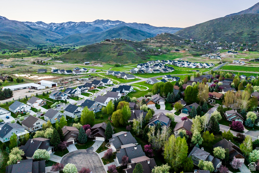 Aerial view of property's location with mountains and nearby suburban area