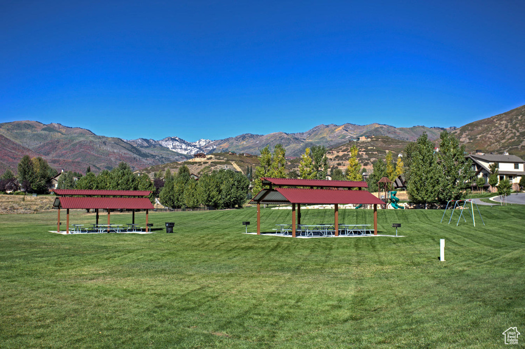 View of community with a gazebo, a mountain view, and a yard