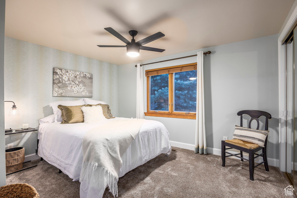Carpeted bedroom with baseboards, a ceiling fan, and a closet