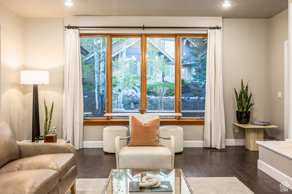 Sitting room with baseboards, wood finished floors, and recessed lighting
