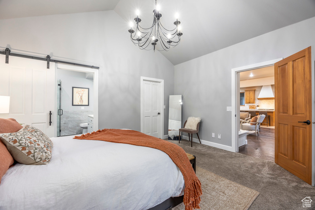 Bedroom featuring high vaulted ceiling, carpet flooring, a chandelier, ensuite bath, and a barn door