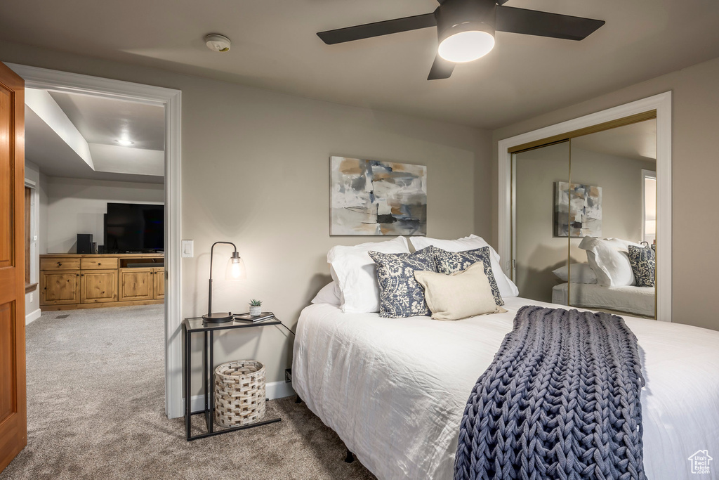 Carpeted bedroom featuring a closet, ceiling fan, and baseboards