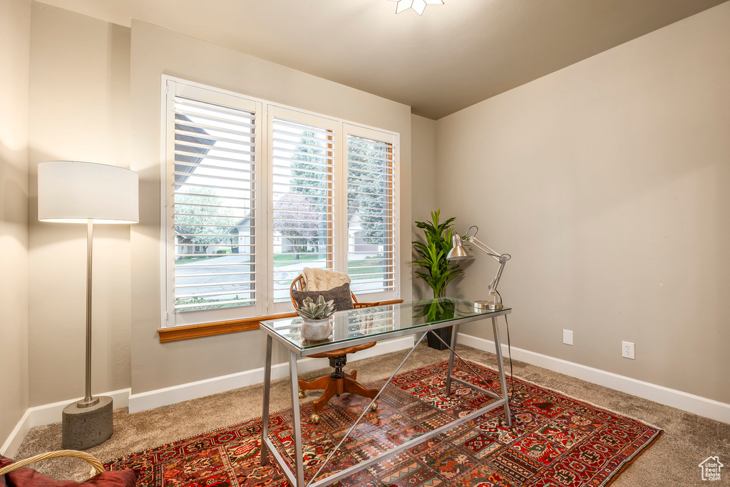 Carpeted home office with baseboards