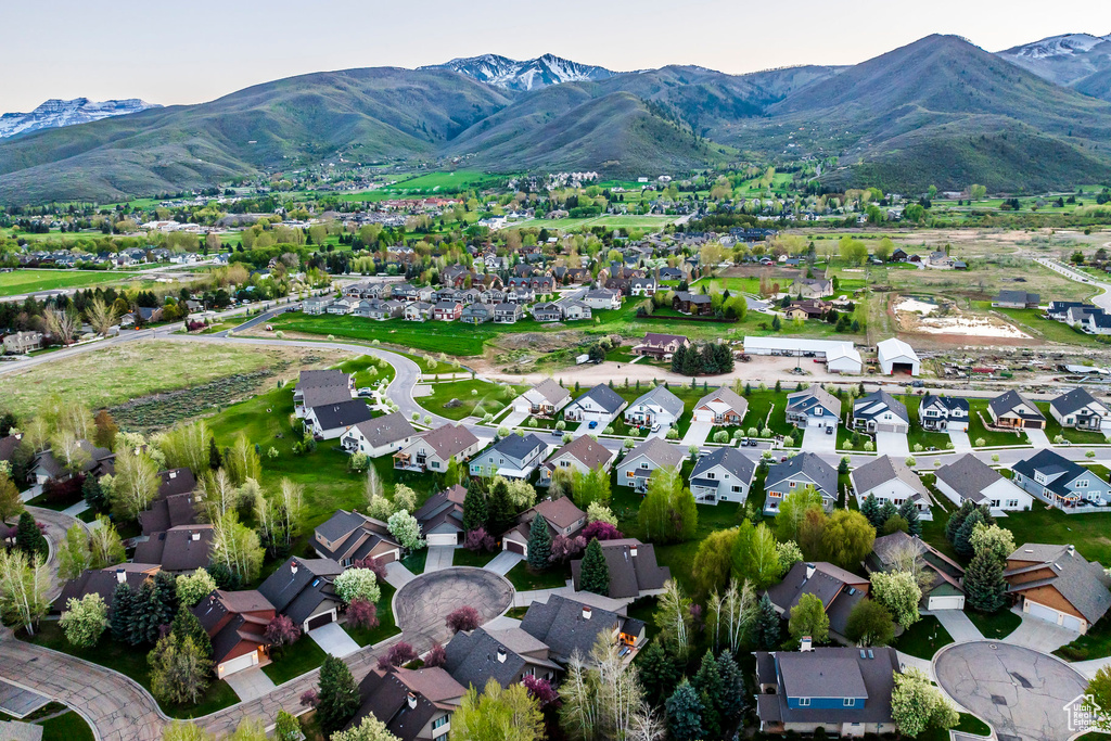 View of property location with a mountain backdrop and nearby suburban area