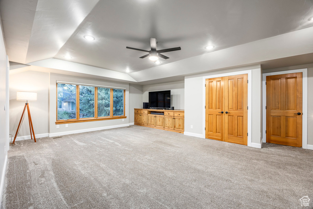 Unfurnished living room featuring a ceiling fan, carpet flooring, baseboards, recessed lighting, and vaulted ceiling