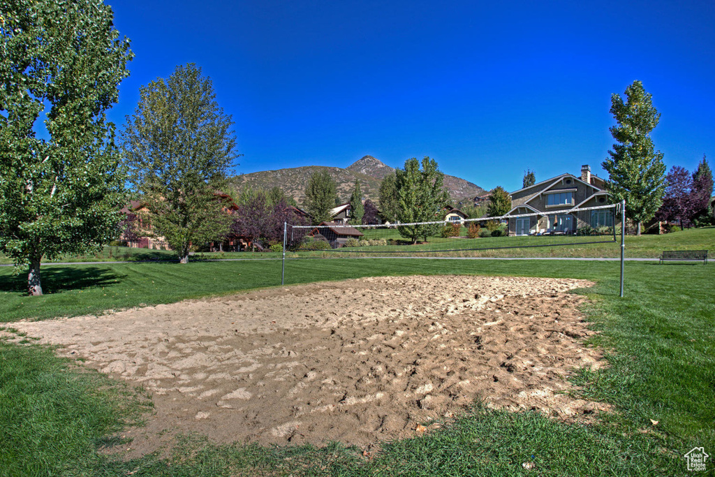 View of property's community with volleyball court, a yard, and a mountain view