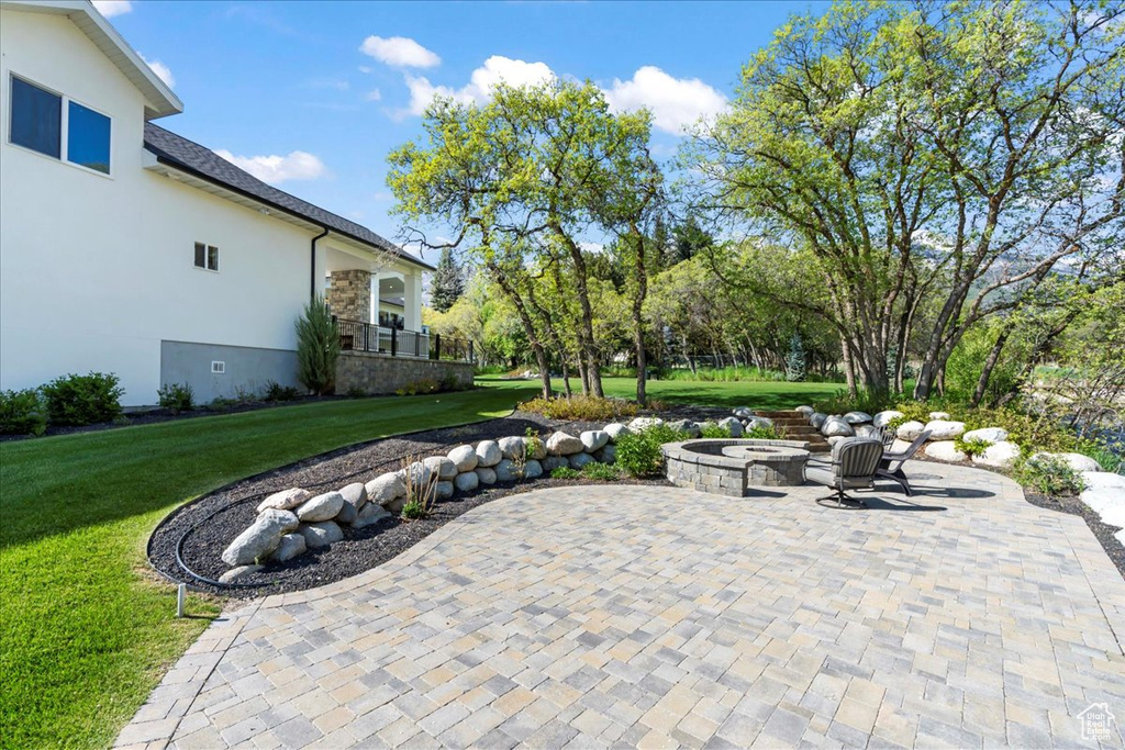 View of patio featuring an outdoor fire pit