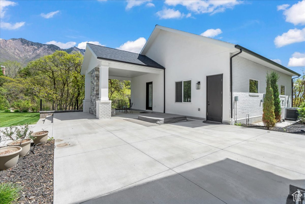 Back of house featuring a patio and a mountain view
