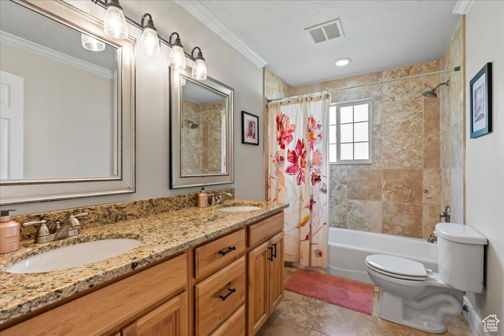 Bathroom with crown molding, toilet, shower / bath combination with curtain, and double vanity