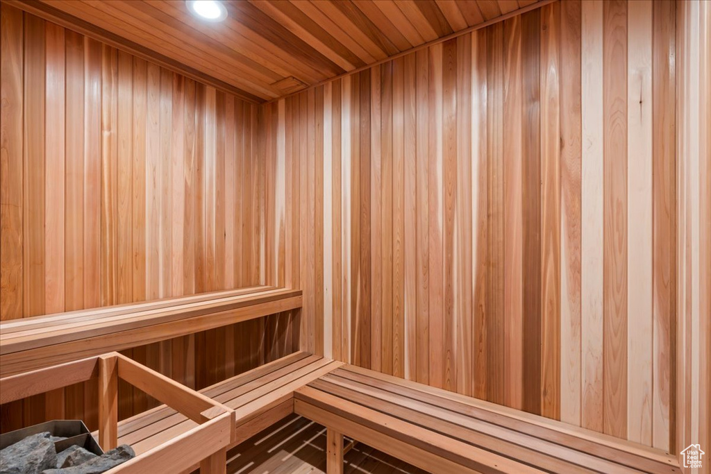 Sauna with recessed lighting and wood walls