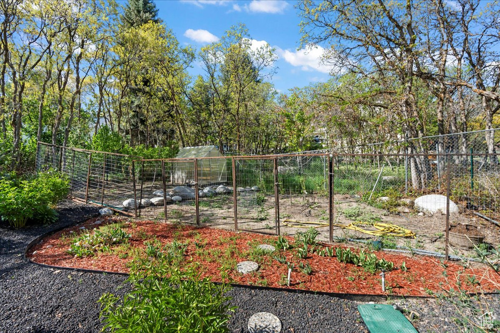 View of yard featuring a vegetable garden and fence