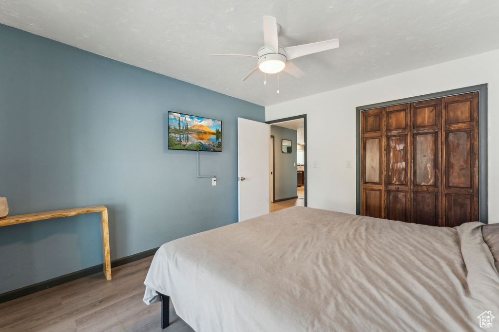 Bedroom featuring wood finished floors, ceiling fan, and baseboards