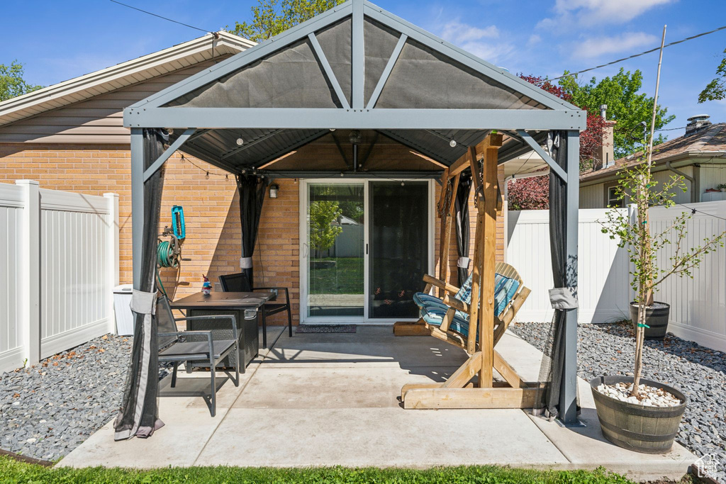 View of patio with a gazebo and a fenced backyard