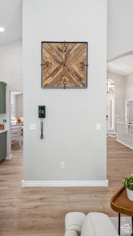 Living area with light wood-style flooring, baseboards, a chandelier, and recessed lighting