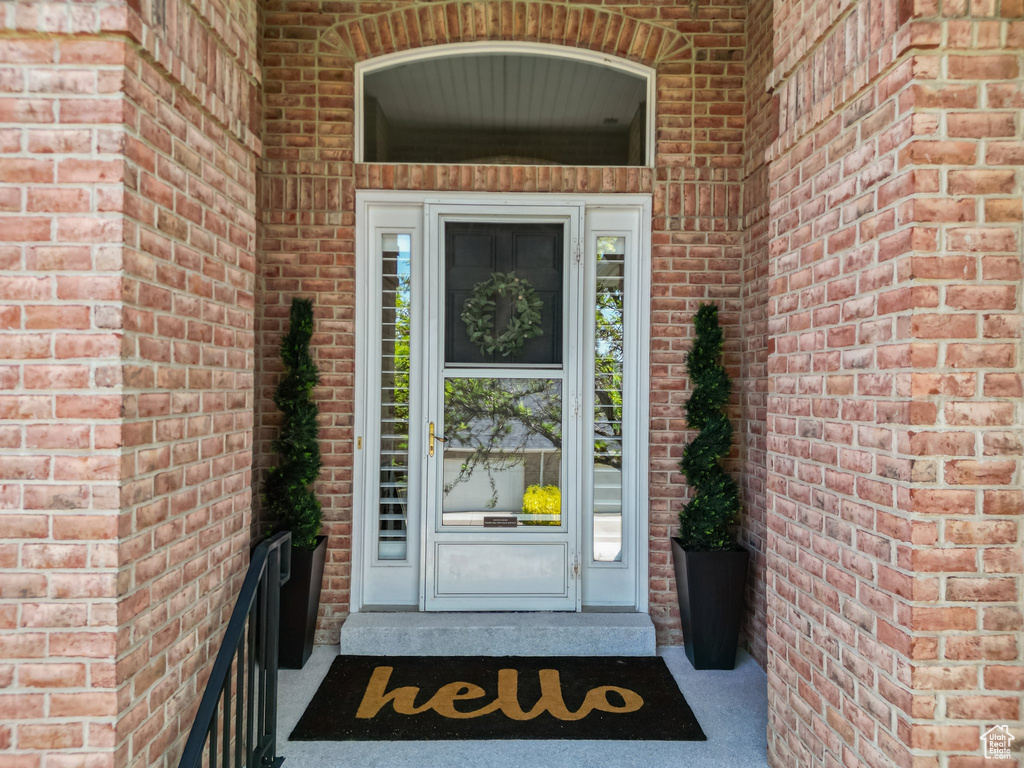 Entrance to property featuring brick siding
