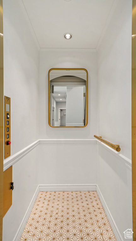 Corridor with ornamental molding and baseboards