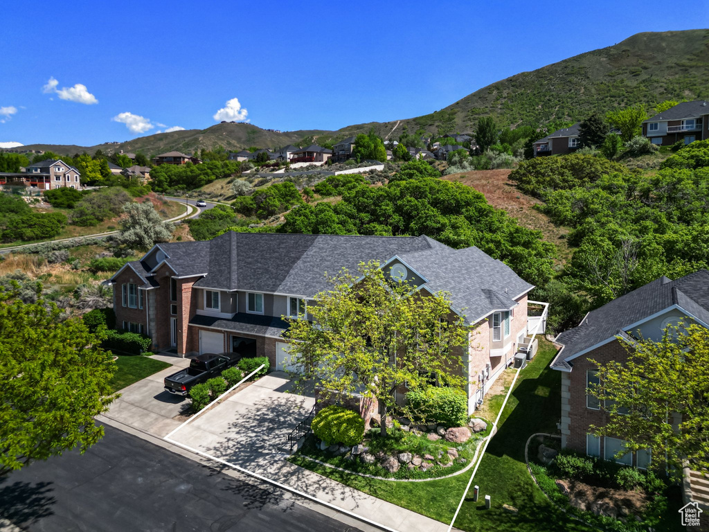 Aerial view of residential area with mountains and property boundaries highlighted