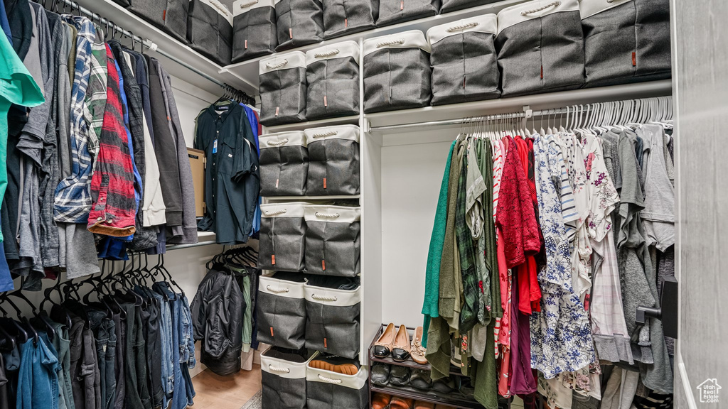 Walk in closet with wood finished floors