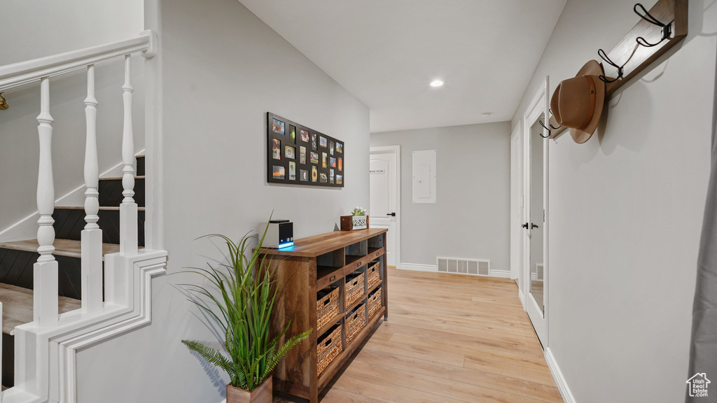 Hallway featuring light wood-style floors, recessed lighting, stairway, and baseboards