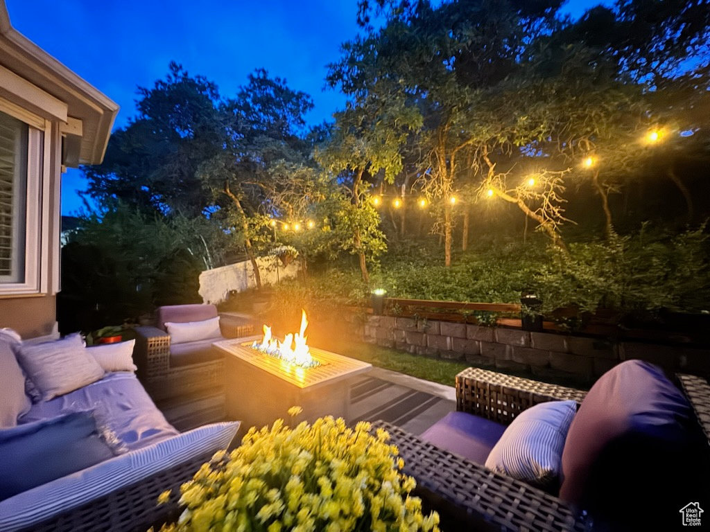 Patio at twilight featuring a fire pit