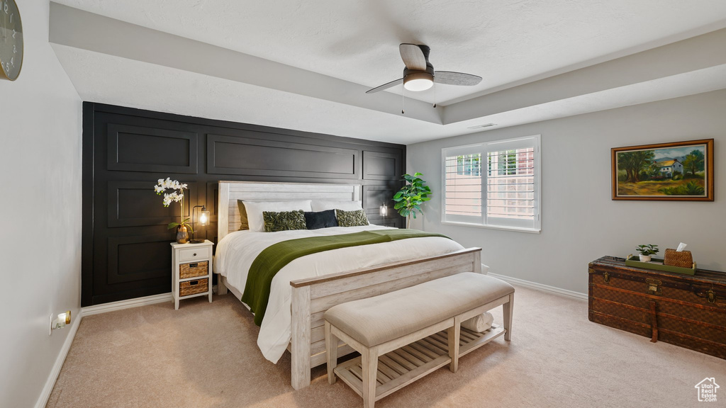 Bedroom with baseboards, light carpet, and ceiling fan