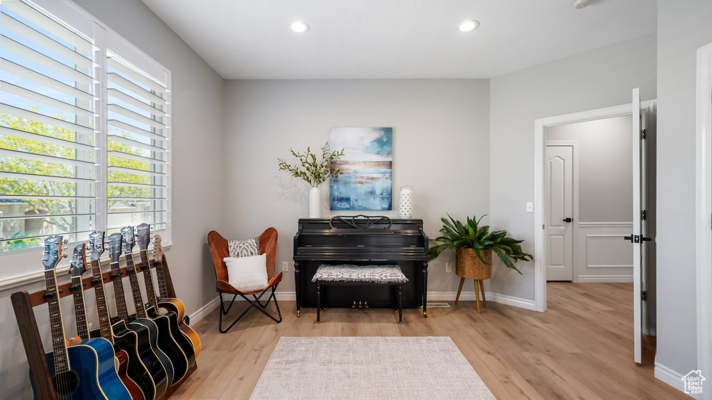 Living area featuring light wood finished floors, recessed lighting, and baseboards