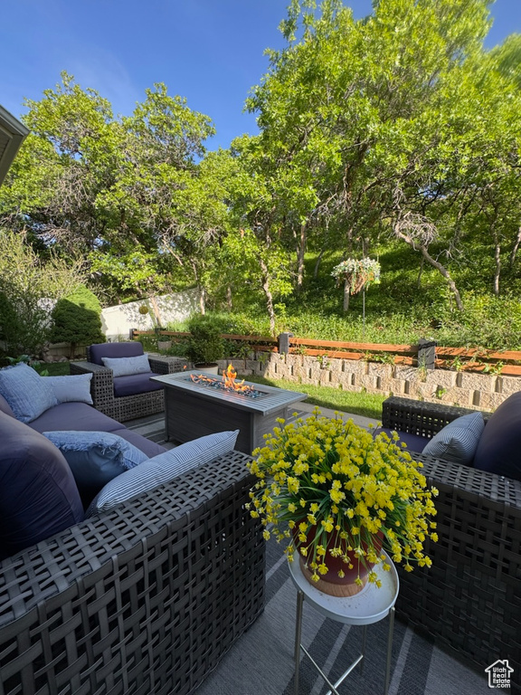 View of patio featuring an outdoor living space with a fire pit