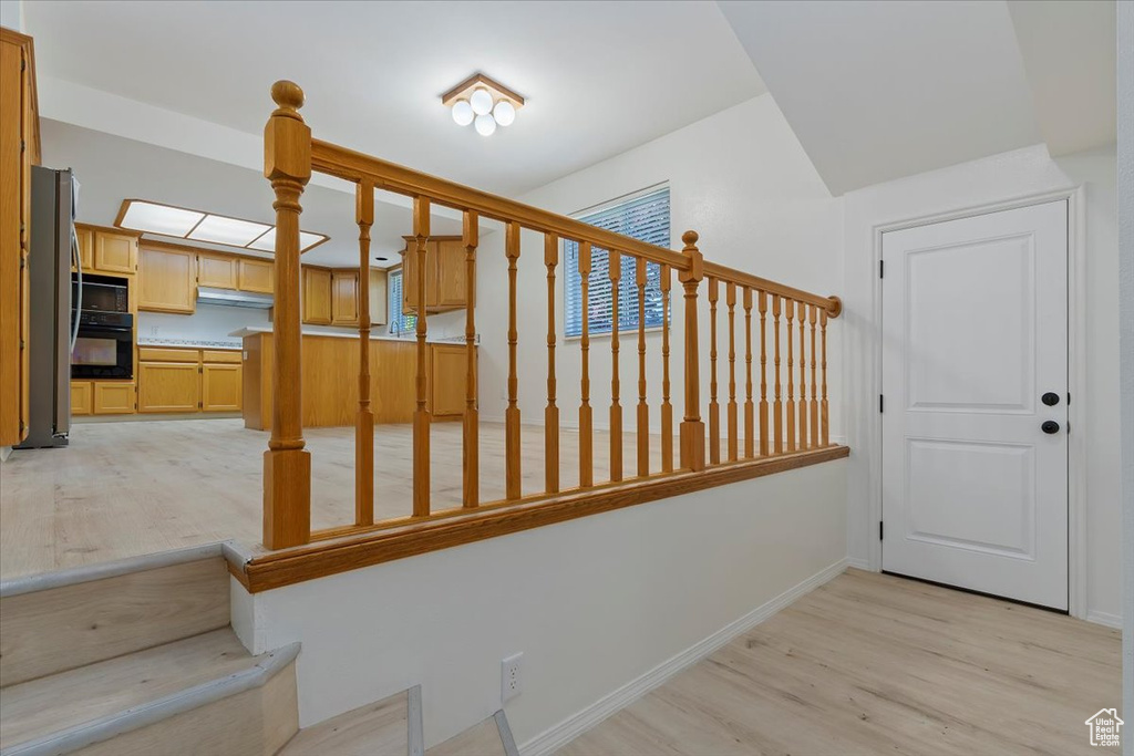 Stairs featuring wood finished floors and baseboards